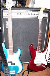 Fender Precision Bass and Stratocaster guitar with Ampeg amplifier